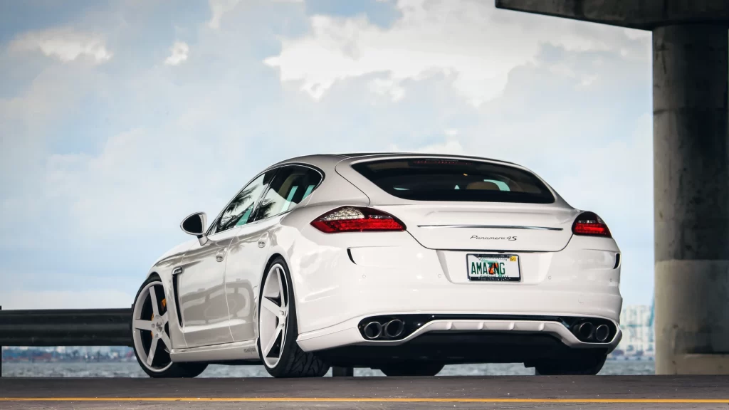 car white Porsche license plate cityscape