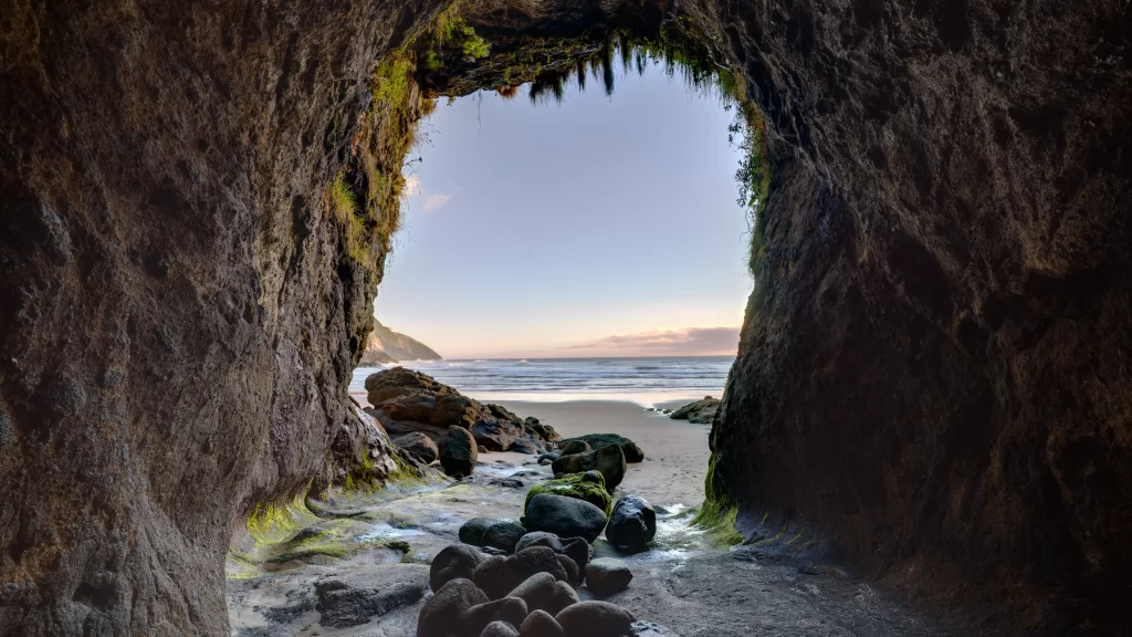 cave beach ocean rocks sunset