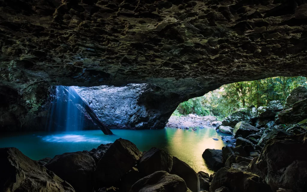 cave waterfall rocks pool forest
