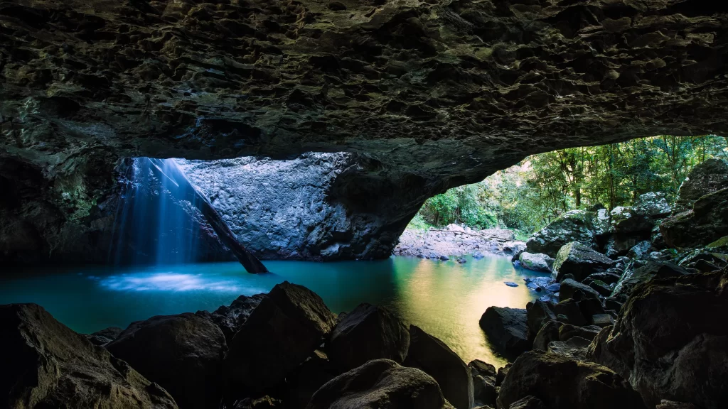 cave waterfall rocks river forest