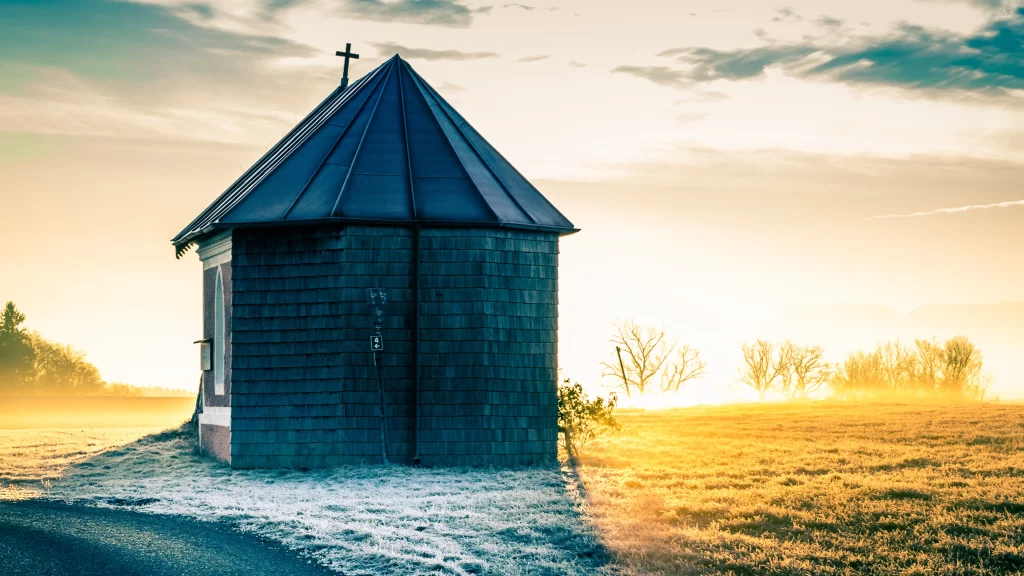 church sunrise field snow clouds