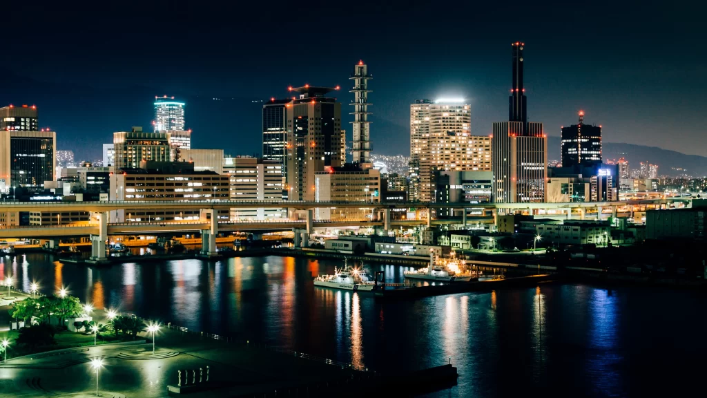 cityscape night lights water bridge buildings