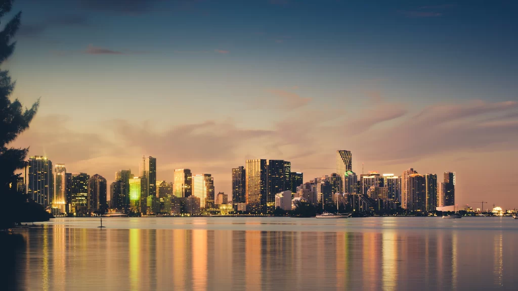 cityscape skyline sunset water reflection buildings lights tranquil