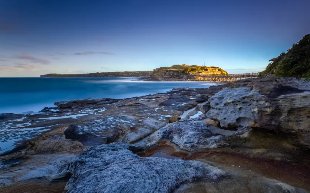 coastal landscape rocky shore ocean waves cliff vegetation