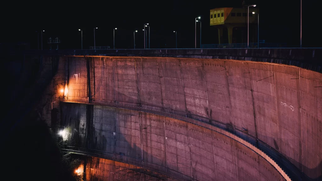 dam night lights reflection water structure