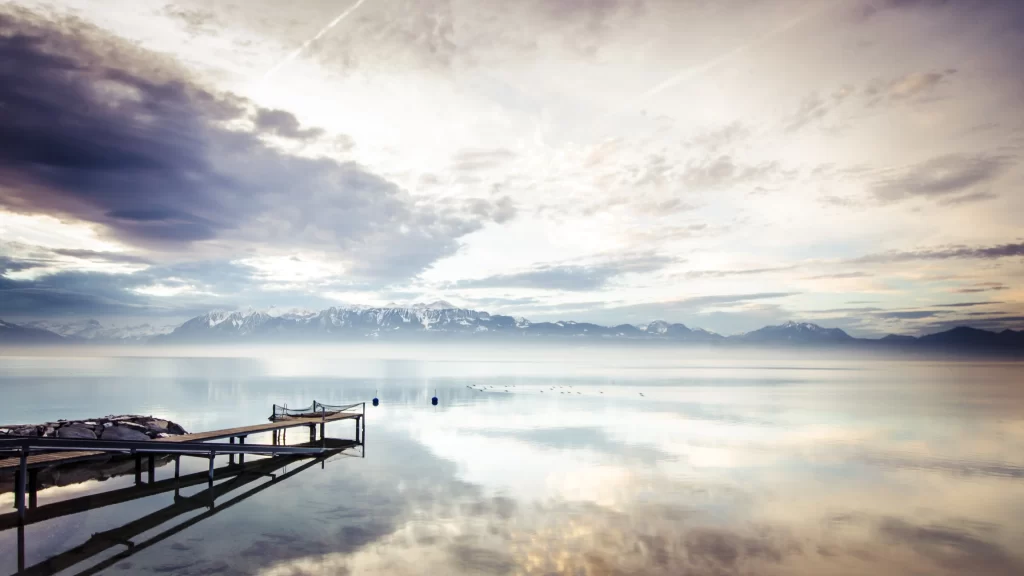 dock lake mountains clouds reflection sunrise
