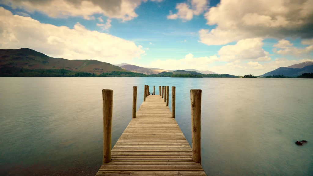dock lake mountains sky clouds wooden