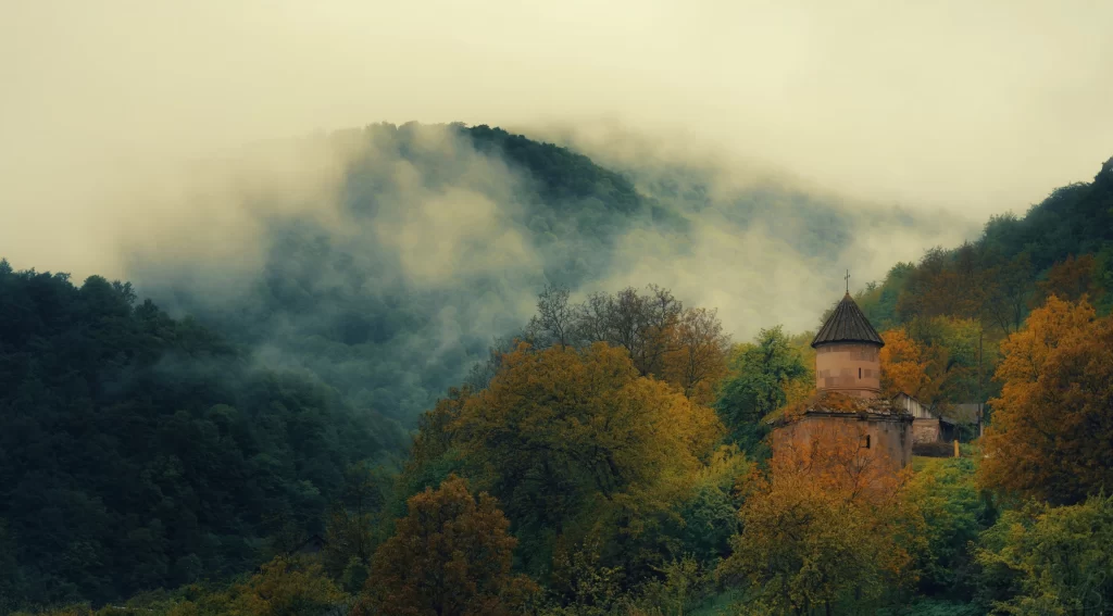 fog autumn trees church mountains mist