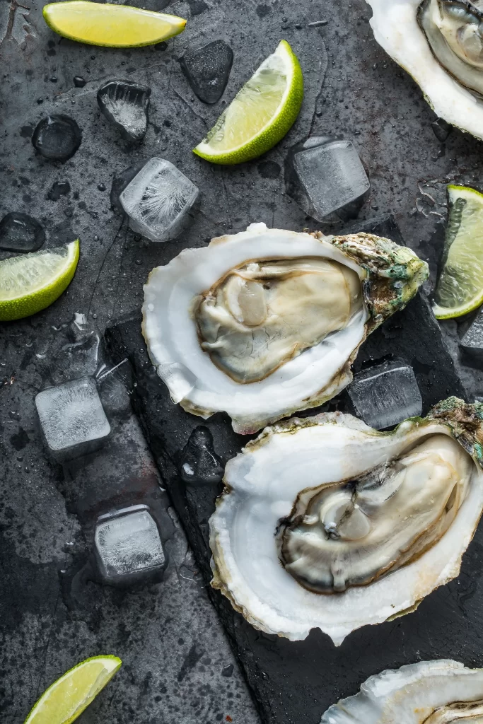 Fresh Oysters Open Shell Lime Wedges Ice Cubes Dark Surface