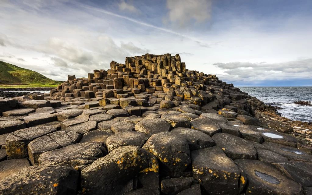 hexagonal rocks natural wonder coastal landscape basalt columns rugged terrain s