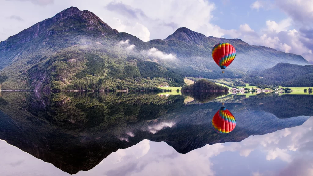 hot air balloon mountain lake reflection clouds landscape