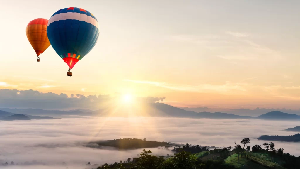 hot air balloons sunrise mountains clouds landscape nature