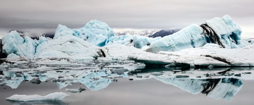 Icebergs cold water reflection snow mountains