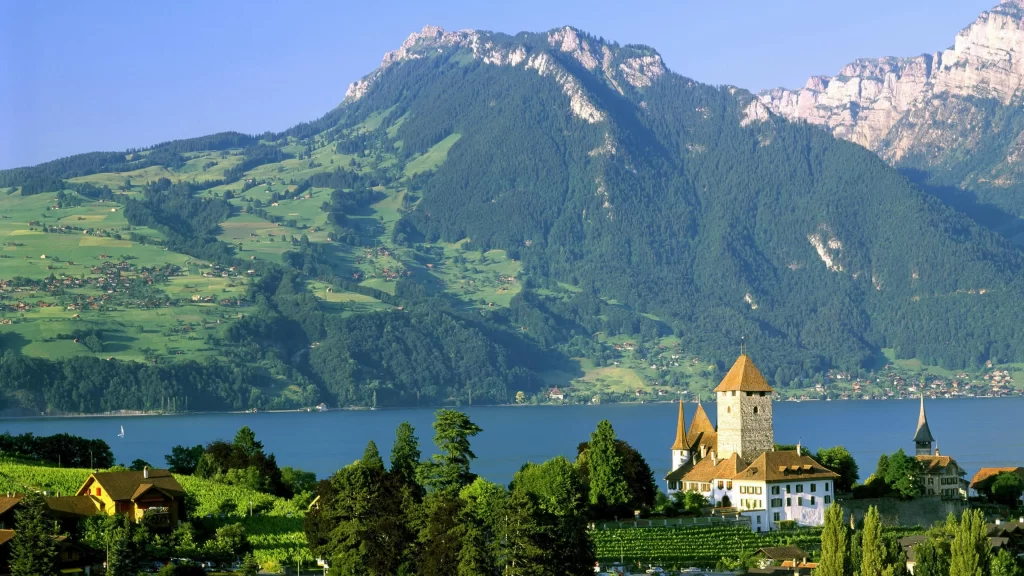 lake mountain village castle green trees