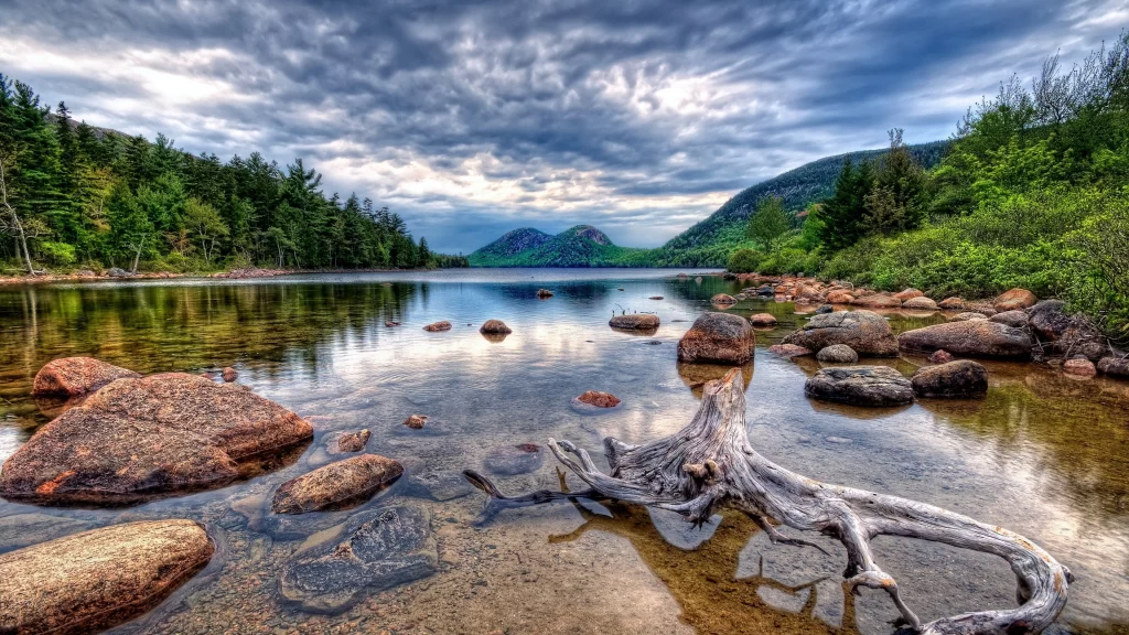 lake rocks trees sky clouds reflection
