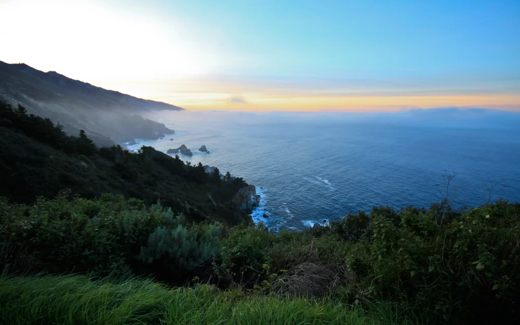 Sunset Ocean Waves Rocky Coastline Greenery Mountain