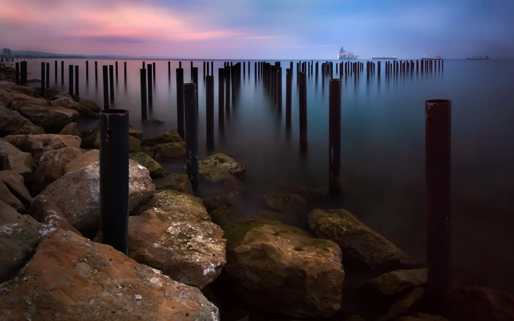 Twilight Calm Water Rocks Poles Industrial