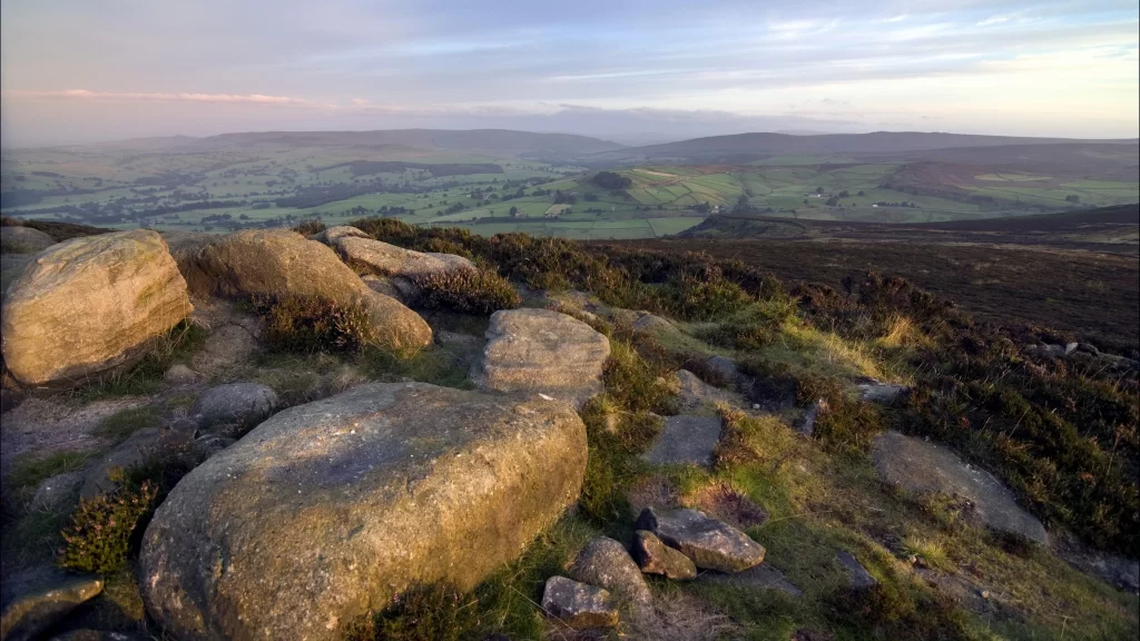 landscape hills rocks vegetation sky clouds