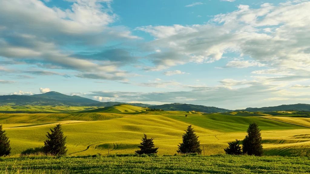 landscape hills trees sky clouds sunlight
