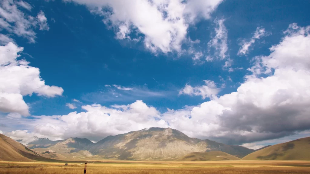 landscape mountains sky clouds field horizon