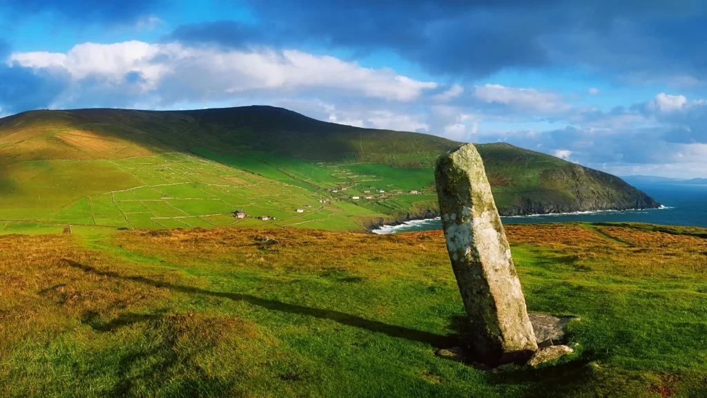 landscape stone grass ocean sky clouds