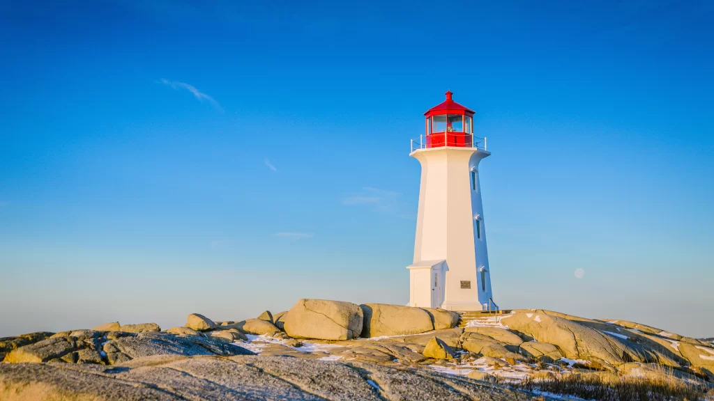 lighthouse rocky clear sky white red daytime