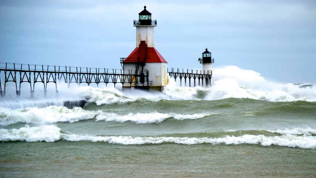 lighthouse stormy waves pier clouds sea