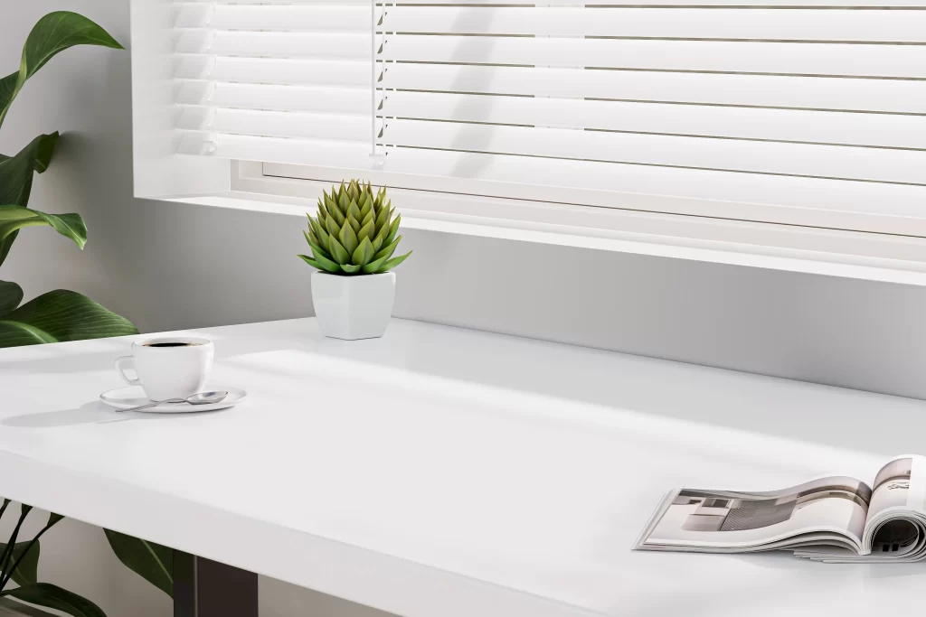 Minimalist White Desk Workspace with Coffee and Plant