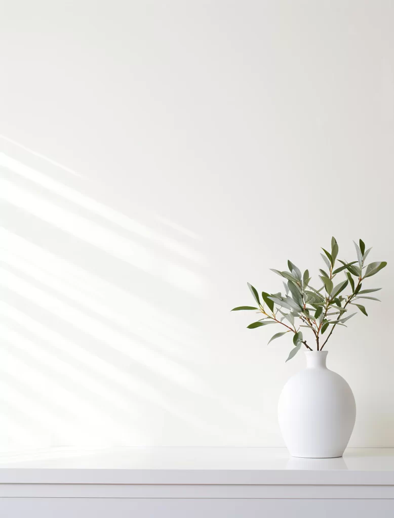 Minimalist White Vase with Green Branches in Bright Room