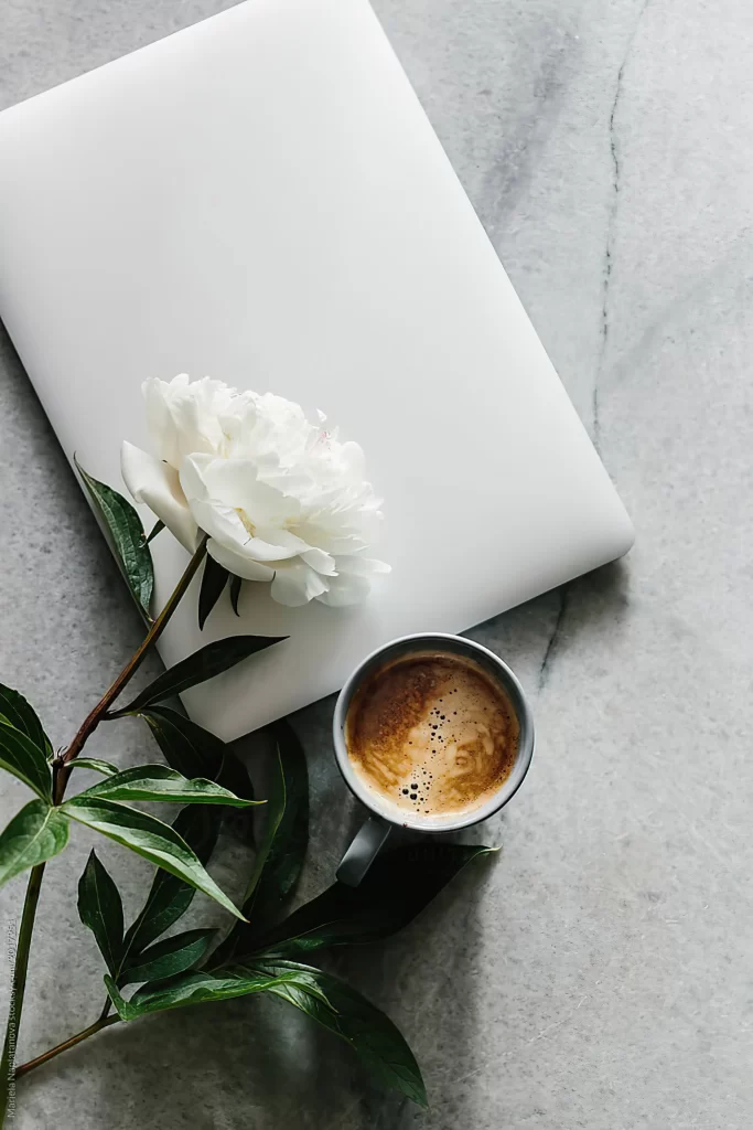 Minimalist Workspace Flat Lay with Laptop Coffee and White Peony
