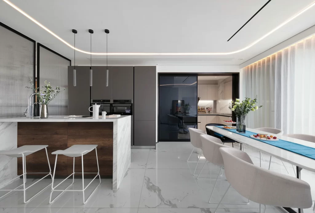 Modern Kitchen Dining Area Neutral Tones Sleek Cabinetry Marble Countertop Contemporary Chairs