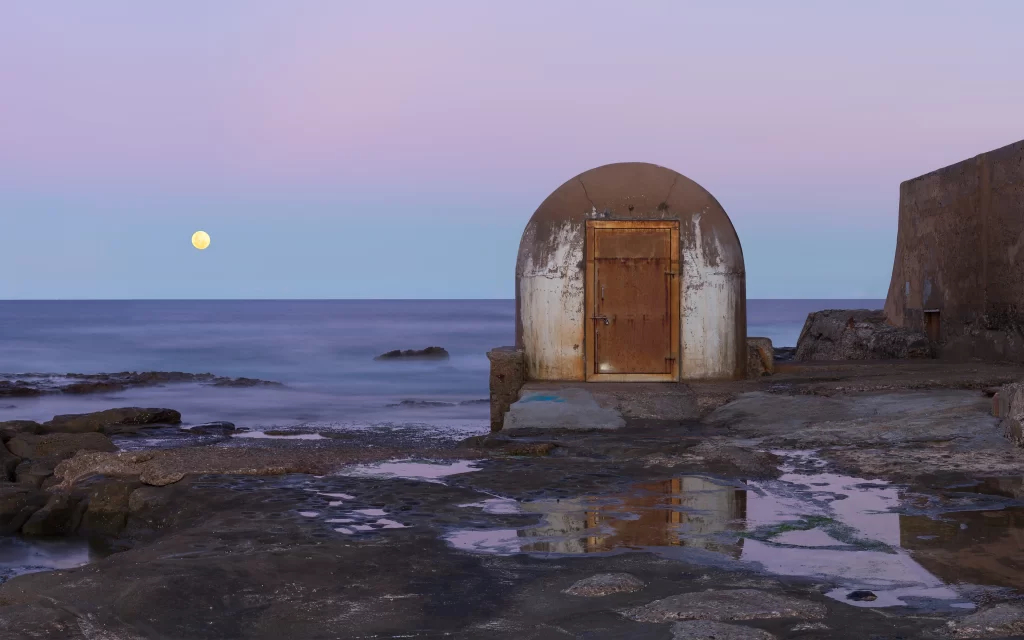 moon rocky shore structure calm twilight
