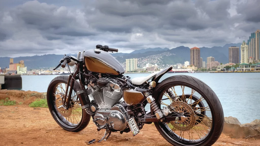 motorcycle cityscape waterfront buildings mountains