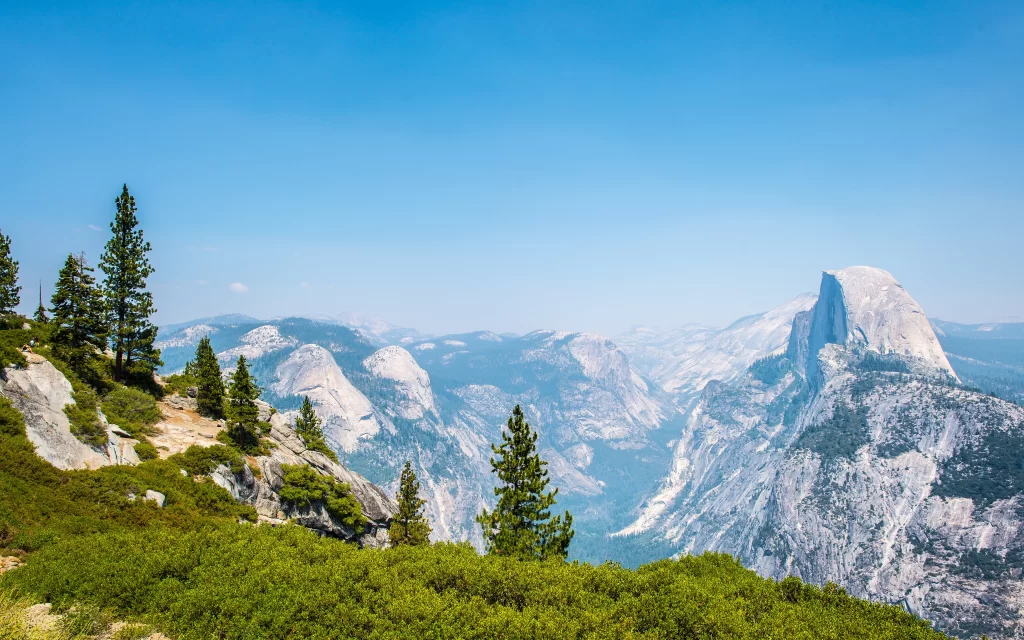 mountain landscape blue sky green vegetation rocky terrain