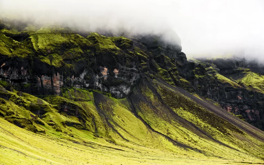 mountain landscape green grass fog rocky terrain