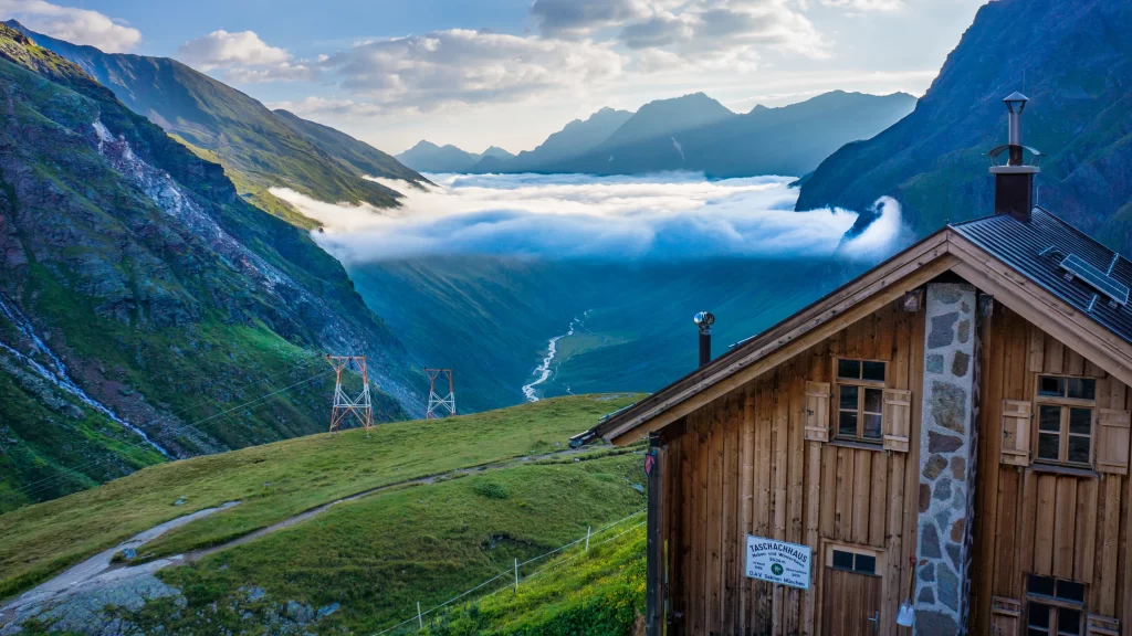 mountains clouds wooden house greenery valley blue sky