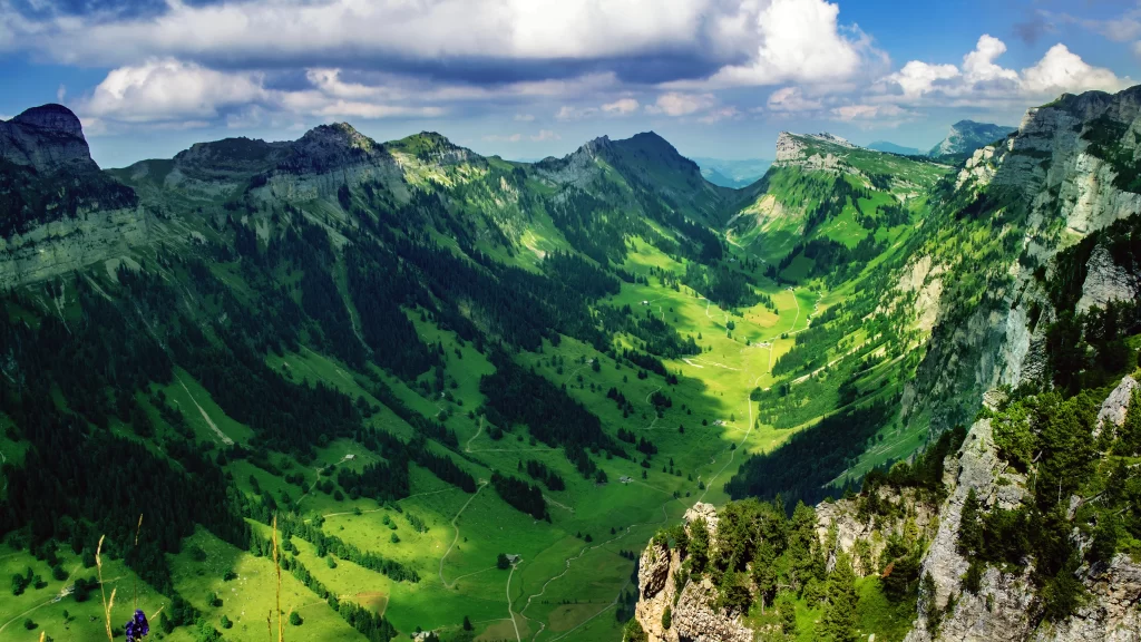 mountains green valley sky clouds