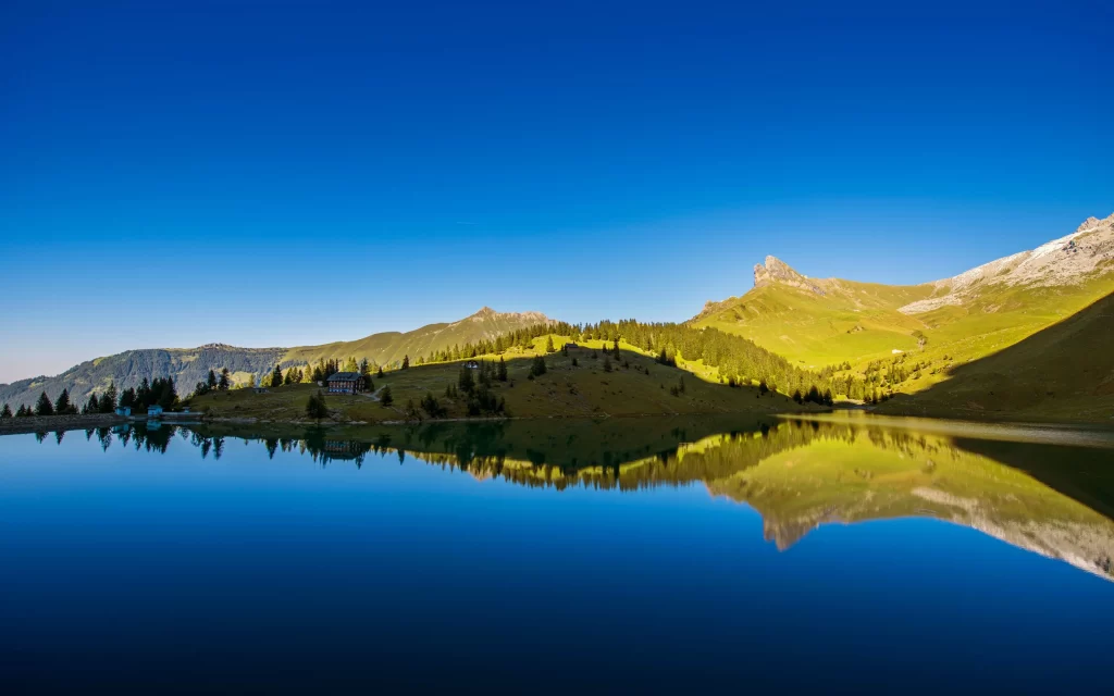 mountains lake reflection trees sky