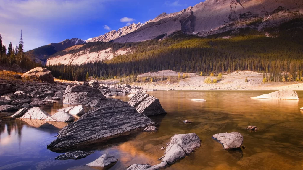 mountains lake rocks forest sky