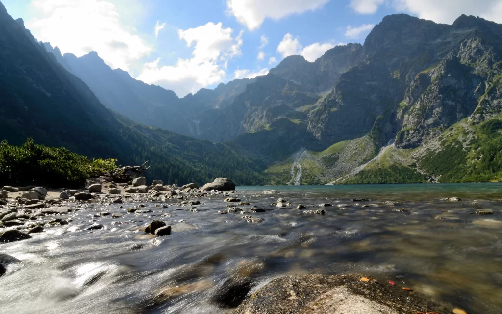 mountains lake rocks water sky