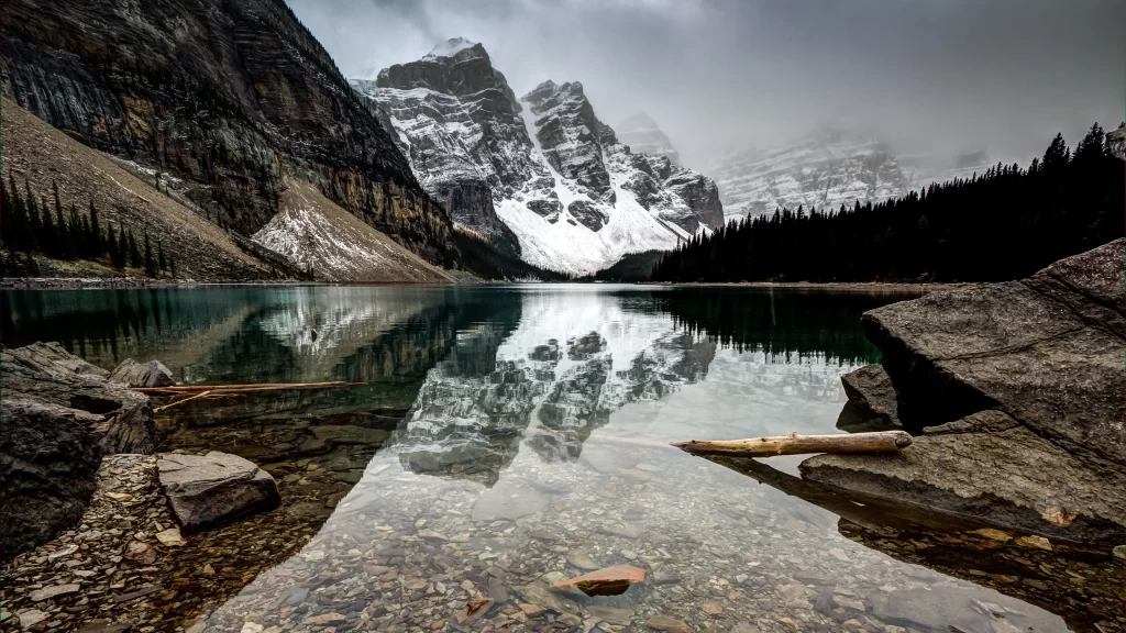 mountains lake snow reflection rocks