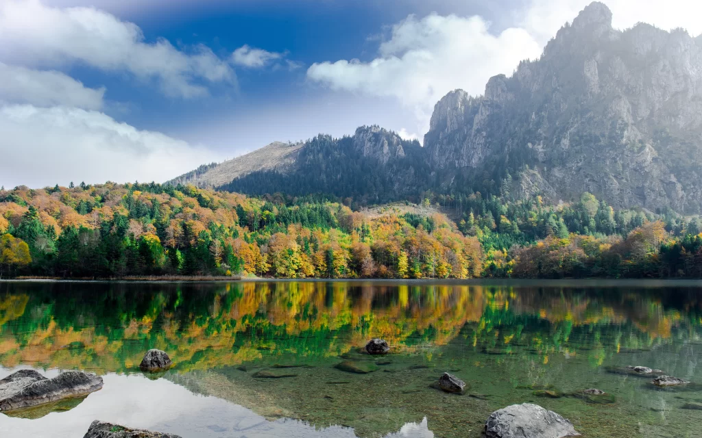 mountains lake trees autumn reflection rocks