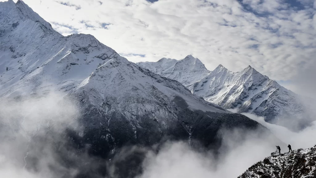 mountains snow clouds sky hikers