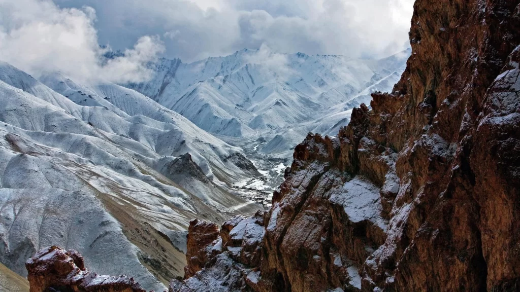 mountains snow clouds valley rocky