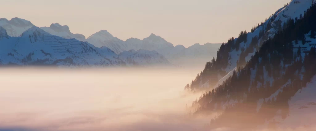 mountains snow fog sunrise landscape serene