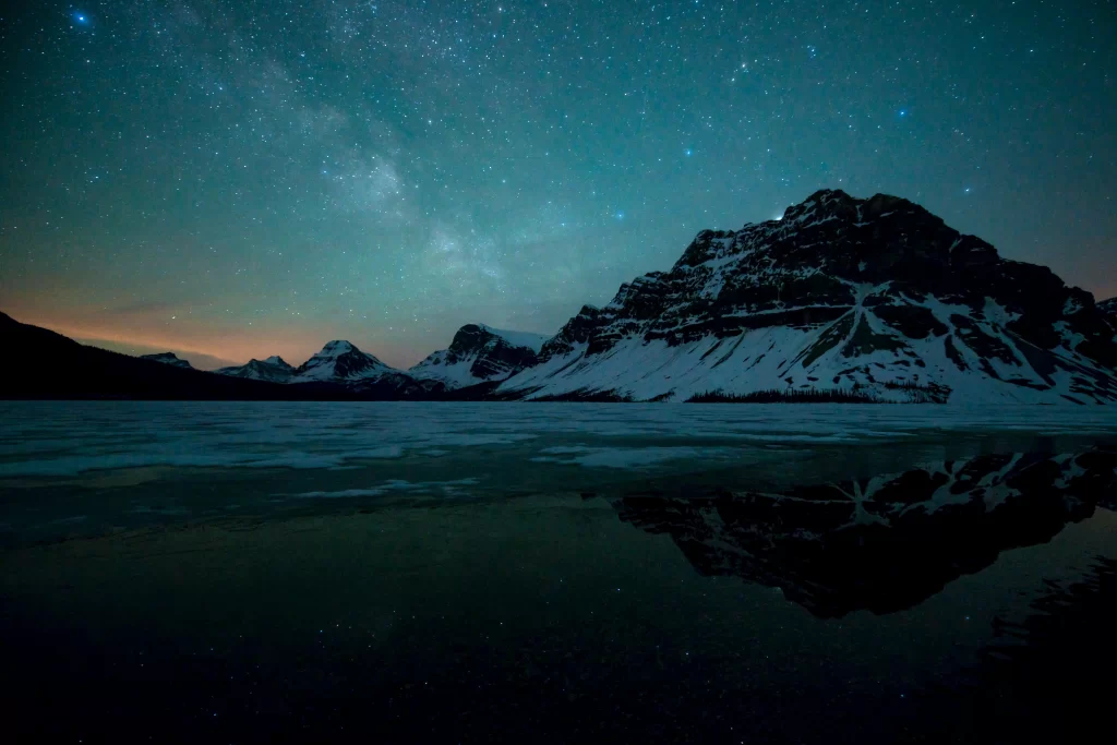 mountains snow stars night sky reflection