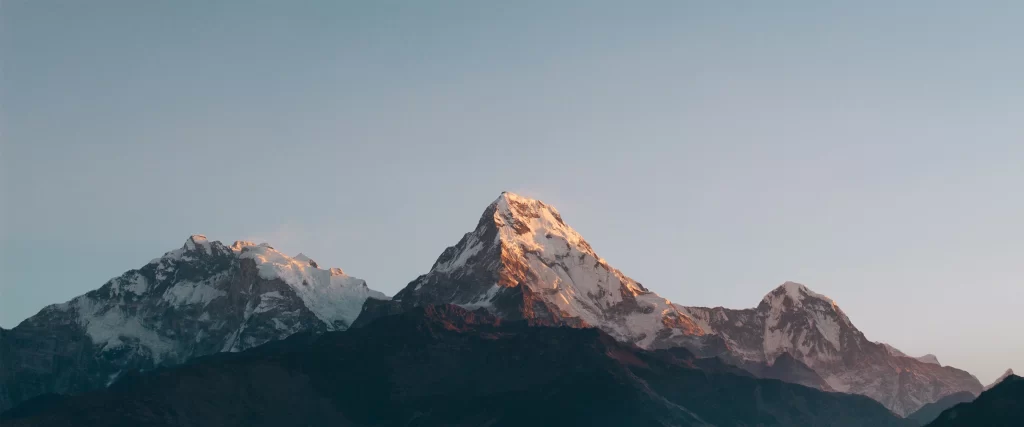 mountains snow sunrise peaks clear sky