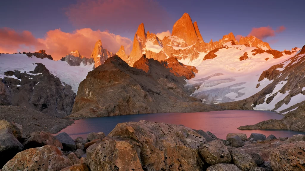 mountains snow sunset lake rocks
