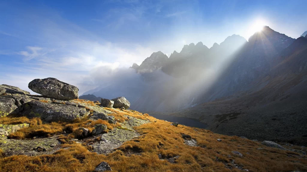 mountains sunlight clouds rocks grass