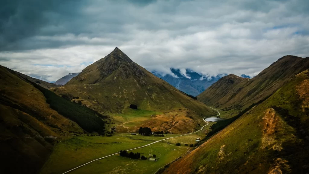 mountains valley green grass clouds sky
